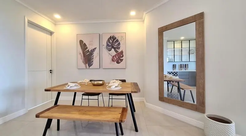 Dining table with a bench and botanical prints