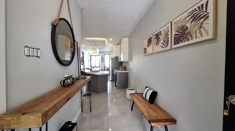 Entry hallway with a timber console and round mirror