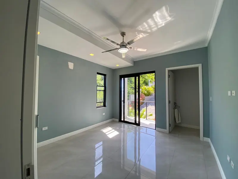 Second bedroom with a sliding door to a small balcony