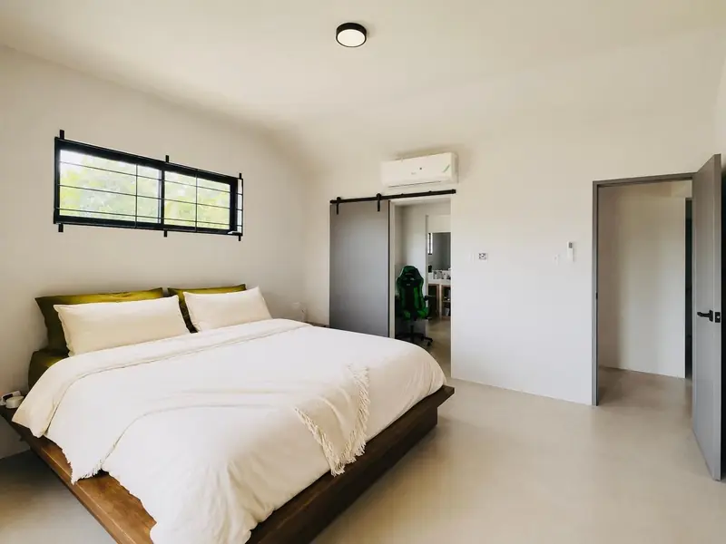 Bedroom with a king bed, air conditioning and a sliding barn door