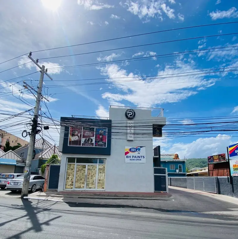 Corner commercial building on Main Street, Ocho Rios, with a glass shopfront on the ground floor