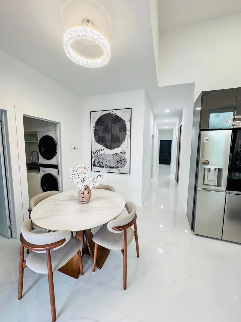 Round dining table by the kitchen and hallway