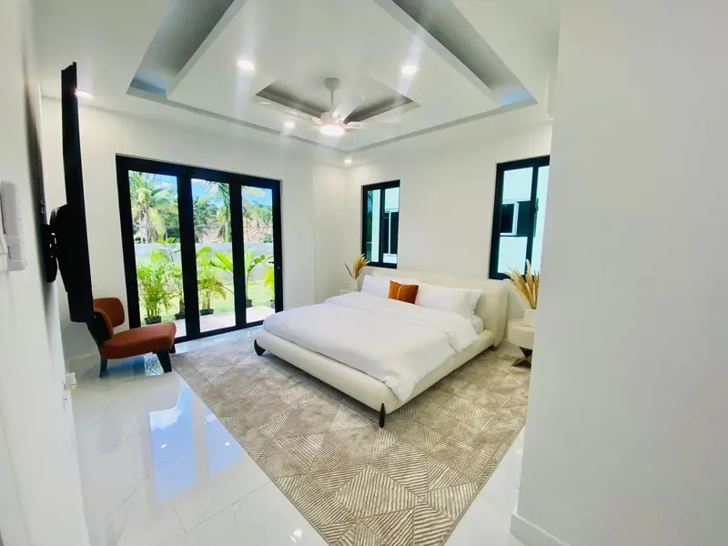 Primary bedroom with a king bed and glass doors to the garden
